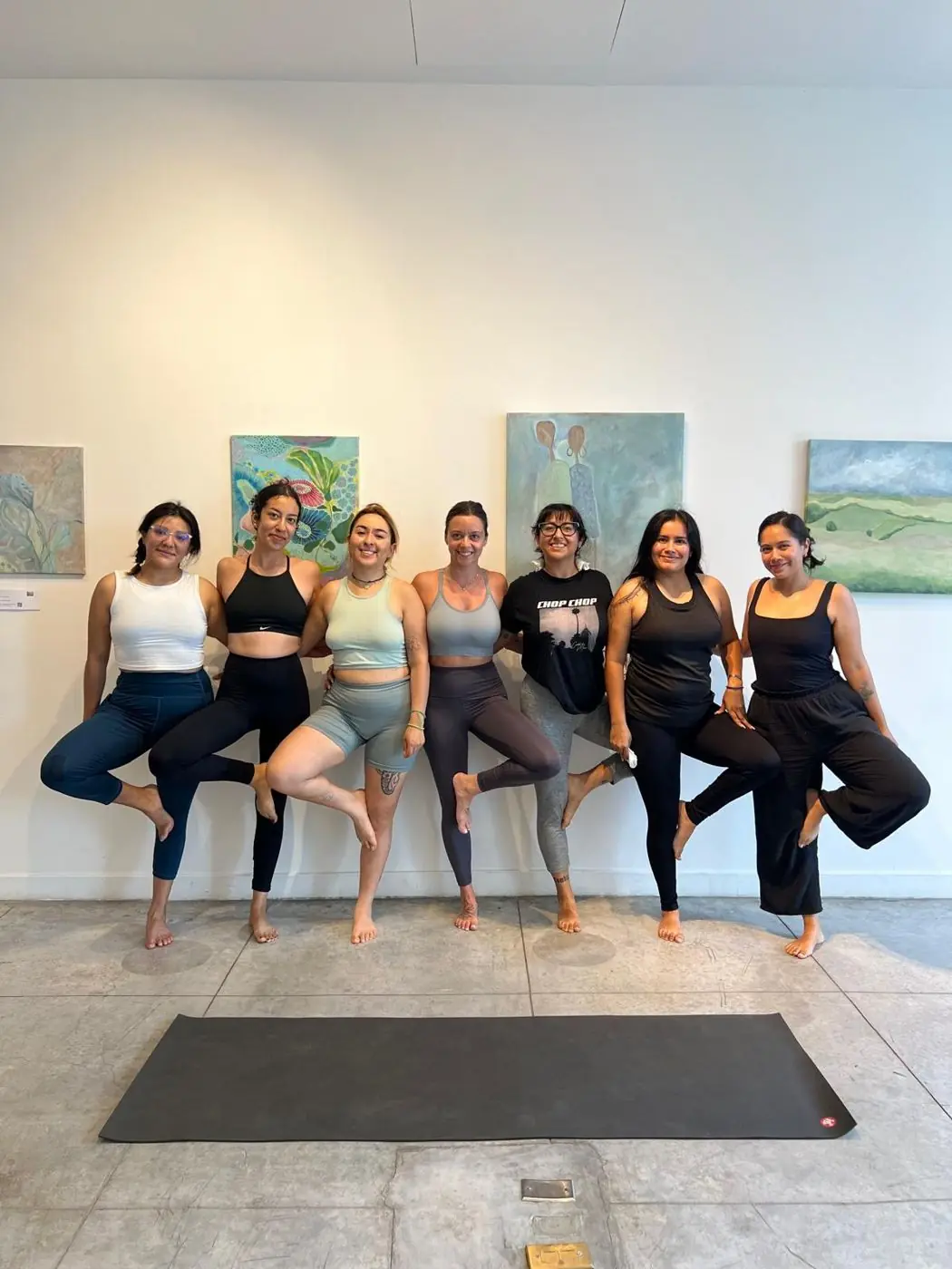 Women from the La Playa community in tree pose after class