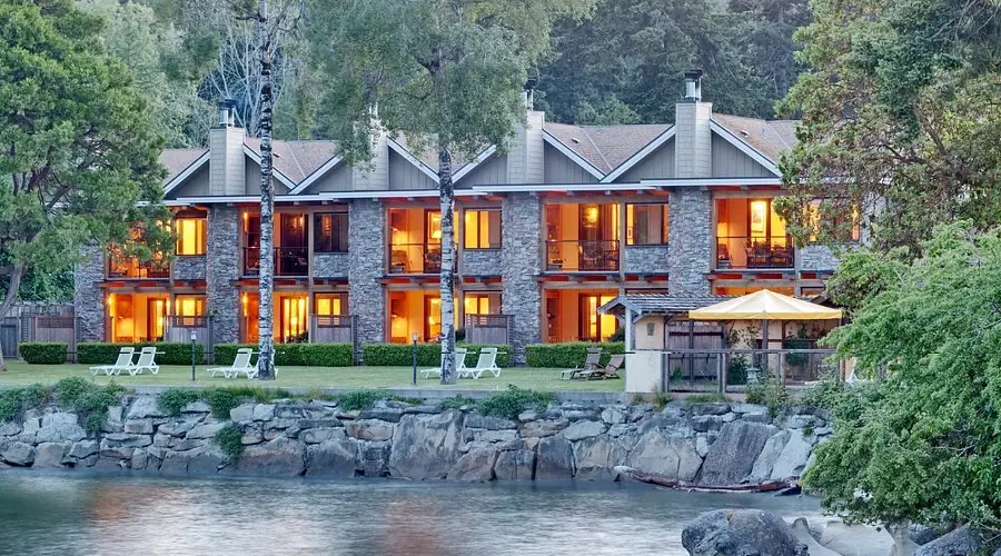 Galiano Oceanfront Inn & Spa lit up at dusk on the water