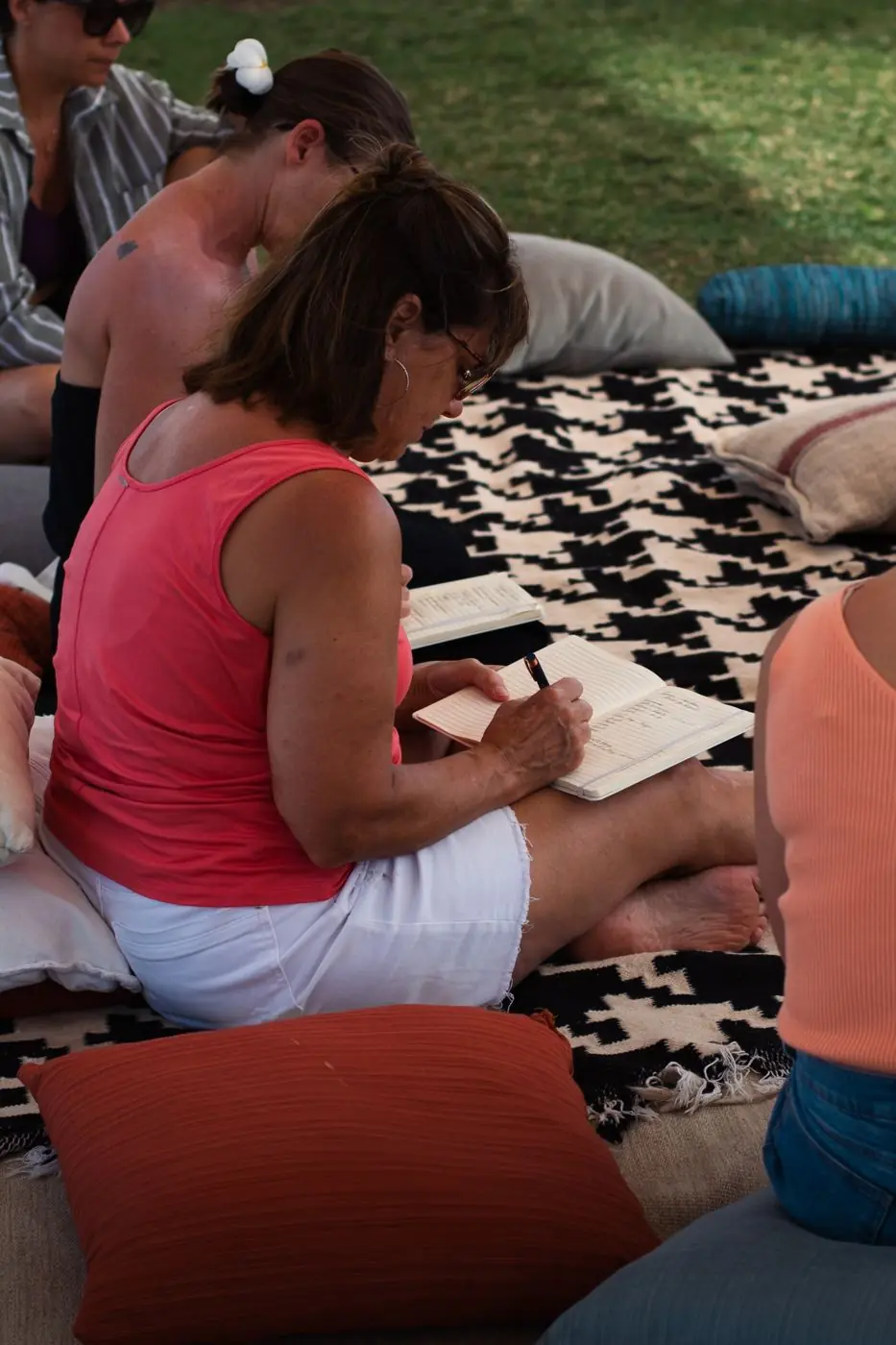A guest journaling on floor cushions