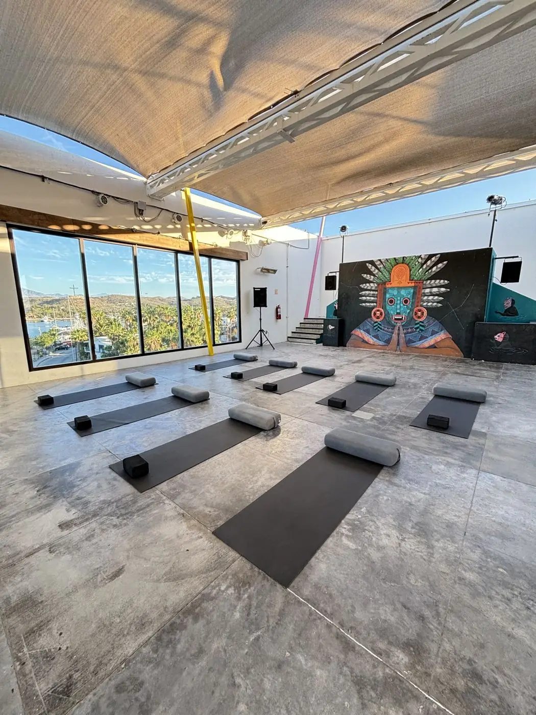 The rooftop event space at El Ganzo with its mural and marina view